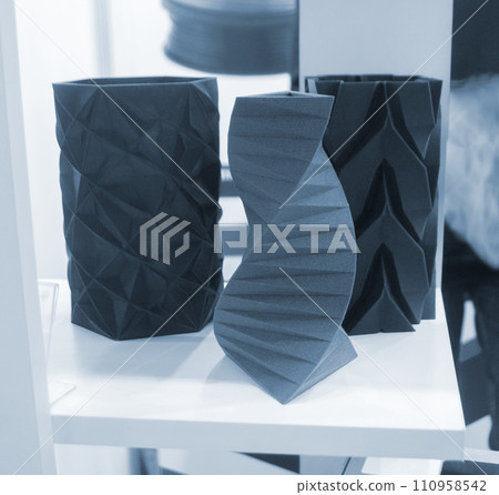 Art object vase printed on a 3D printer. Models created by a 3D printer from blue molten plastic. Concept 3d printing. Additive progressive technologies. New modern technology for creating objects 110958542