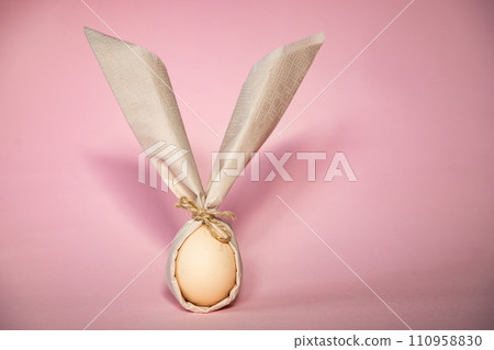 egg wrapped in easter bunny shaped napkin egg wrapped in easter bunny shaped napkin 110958830