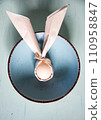 egg wrapped in easter bunny shaped napkin 110958847