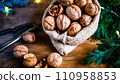 festive christmas nuts tumbling from a burlap bag 110958853