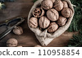 festive christmas nuts tumbling from a burlap bag 110958854