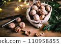 festive christmas nuts tumbling from a burlap bag 110958855