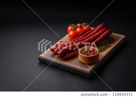 Delicious thin smoked hunting sausages with salt, spices and herbs 110959331