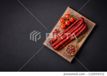 Delicious thin smoked hunting sausages with salt, spices and herbs 110959332