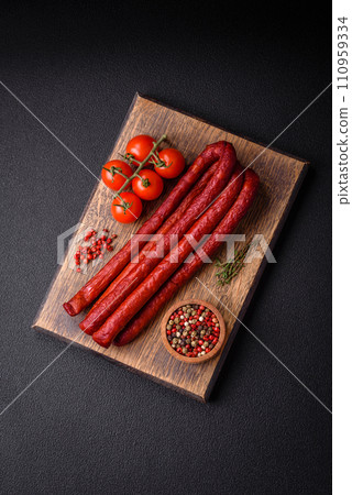 Delicious thin smoked hunting sausages with salt, spices and herbs Delicious thin smoked hunting sausages with salt, spices and herbs 110959334
