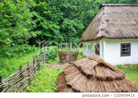 Wooden ethnic house with thatched roof. Halych Ethnography museum, Ukraine. Wooden ethnic house with thatched roof. Halych Ethnography museum, Ukraine. 110959433