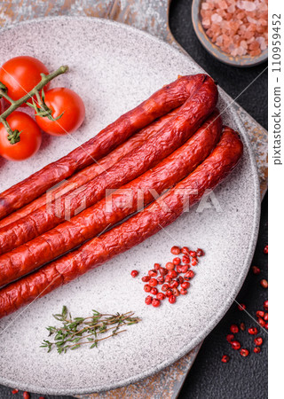 Delicious thin smoked hunting sausages with salt, spices and herbs Delicious thin smoked hunting sausages with salt, spices and herbs 110959452