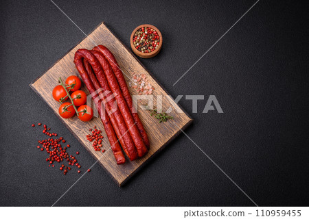 Delicious thin smoked hunting sausages with salt, spices and herbs Delicious thin smoked hunting sausages with salt, spices and herbs 110959455
