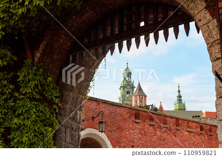 An old vintage metal gate with an archway to the old Zamek Krolewski na Wawelu castle in the center of Krakow. 110959821