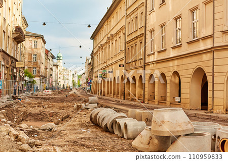 Extensive repair work on sewerage and water supply in the ancient streets of Europe. The road was dug up to replace old pipes with new ones. Extensive repair work on sewerage and water supply in the ancient streets of Europe. The road was dug up to replace old pipes with new ones. 110959833