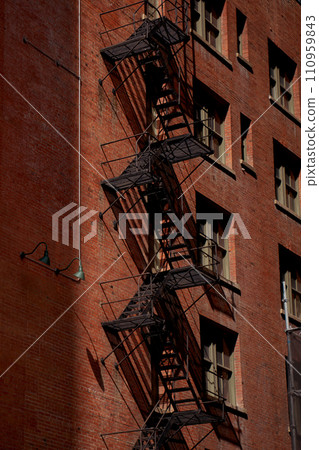 Old fire escape on an old brick wall. American vintage style. 110959843