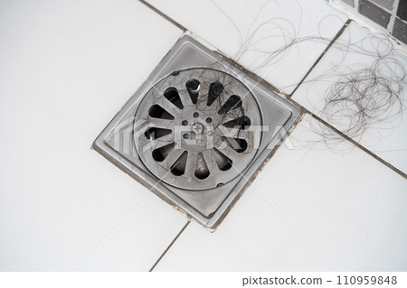 Close-up Pile of hair loss in bathroom after wash hair.hair fall everyday serious problem, on white background.Solutions for hair loss 110959848