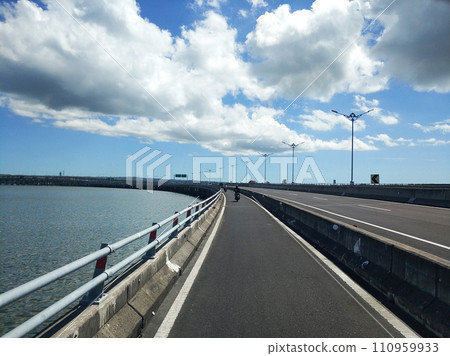 Riding along the part of the toll road designated for motorcycles across the water Riding along the part of the toll road designated for motorcycles across the water 110959933