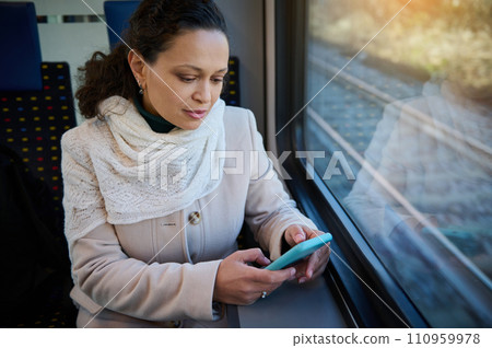 Happy young woman, commuter enjoying train travel to go to work in the morning 110959978