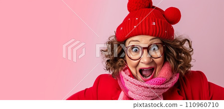 Elderly woman in knitted hat and scarf looking away, isolated on pastel background with copy space 110960710