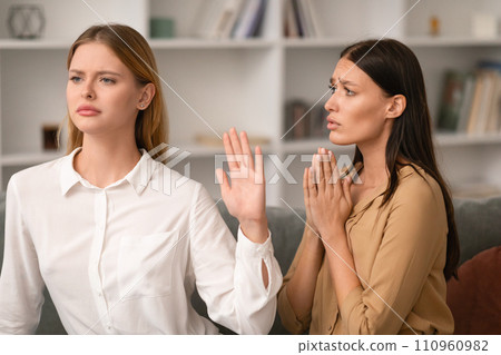 Woman Gesturing Stop In Refusal To Friend Begging Favor Indoor Woman Gesturing Stop In Refusal To Friend Begging Favor Indoor 110960982