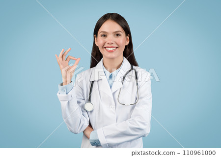 Happy young female doctor showing OK sign with hand 110961000