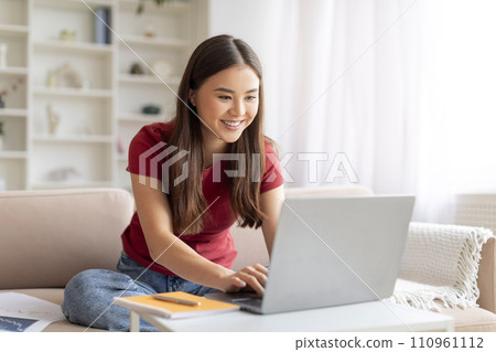 Freelance Concept. Happy Young Asian Woman Working On Laptop At Home Freelance Concept. Happy Young Asian Woman Working On Laptop At Home 110961112