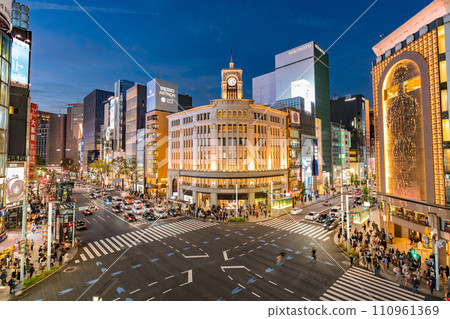 Ginza sidewalk Wako shopping crowd Chuo Ward evening afternoon city center Tokyo road skyscraper car Mitsukoshi night 110961369