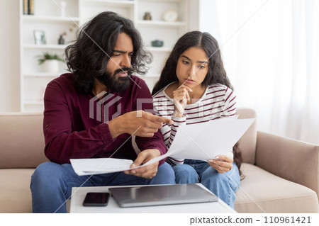 Confused, stressed and upset couple paying bills or debt 110961421