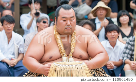 Dynamic shot of traditional japanese male sumo wrestler in action wearing traditional attire 110961490