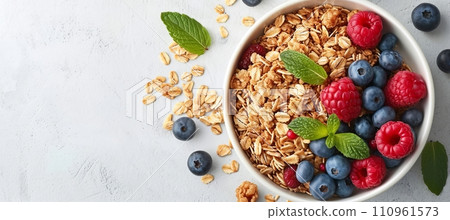Top view of healthy oatmeal porridge with berries in a bowl on a white table, ideal diet breakfast 110961573