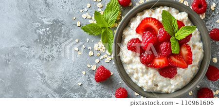 Nutritious oatmeal porridge bowl with berries on white table, healthy diet breakfast, copy space 110961606