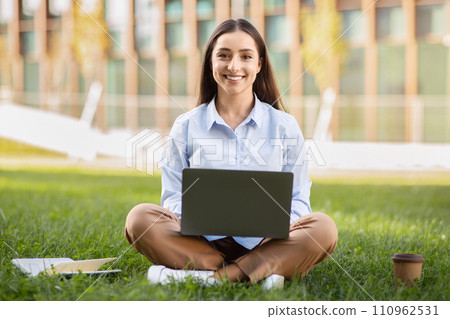 Cheerful pretty calm millennial european lady enjoy work, cup of coffee takeaway, typing by laptop Cheerful pretty calm millennial european lady enjoy work, cup of coffee takeaway, typing by laptop 110962531