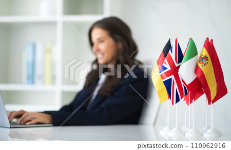 Diverse flags on table in businesswoman office 110962916