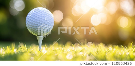 Golfer placing ball on tee at scenic golf course, ample copy space for text or design 110963426