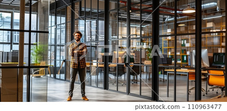 Smiling businessman in modern office meeting room with blurred glass walls background Smiling businessman in modern office meeting room with blurred glass walls background 110963477