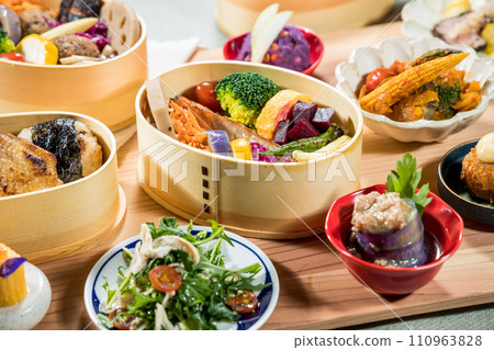 Japanese food in bamboo containers, closeup of a Japanese meal. Japanese food in bamboo containers, closeup of a Japanese meal. 110963828
