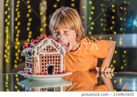 Immerse in festive delight as a boy crafts boy crafting an unconventional gingerbread house, infusing Christmas with unique creativity and festive cheer. A sweet scene of seasonal bonding and culinary Immerse in festive delight as a boy crafts boy crafting an unconventional gingerbread house, infusing Christmas with unique creativity and festive cheer. A sweet scene of seasonal bonding and culinary 110963920