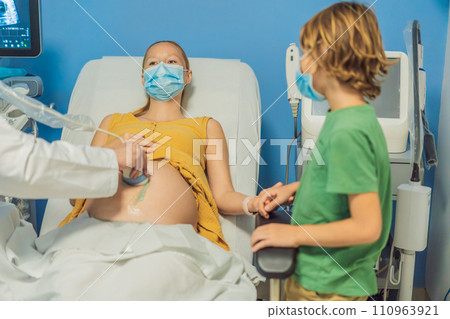 a pregnant mother's ultrasound visit, sharing the excitement with her son who eagerly awaits the arrival of his baby brother. A heartwarming portrayal of family bonds and the anticipation of new a pregnant mother's ultrasound visit, sharing the excitement with her son who eagerly awaits the arrival of his baby brother. A heartwarming portrayal of family bonds and the anticipation of new 110963921