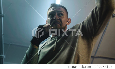 Close up of male fighter training and preparing for fighting match 110964108