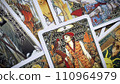 Blurred View of Golden tarot cards background, esoteric concept, fortune telling and predictions, Moscow, Russia - August 2021. 110964979