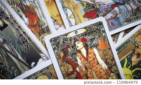 Blurred View of Golden tarot cards background, esoteric concept, fortune telling and predictions, Moscow, Russia - August 2021. 110964979