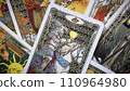 Blurred View of Golden tarot cards background, esoteric concept, fortune telling and predictions, Moscow, Russia - August 2021. 110964980