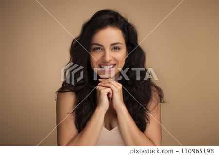 Portrait of beautiful millennial woman posing on beige 110965198