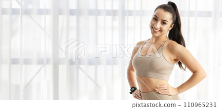 Attractive young sporty lady posing next to window 110965231