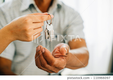 New homeownership showcased by a joyous couple holding keys to their new house radiating happiness and success. Reflecting achievement excitement and a significant real estate investment. 110966097