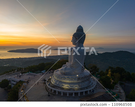 aerial view bright golden sun ray shine on the head of Phuket big Buddha.. aerial view bright golden sun ray shine on the head of Phuket big Buddha.. 110968508