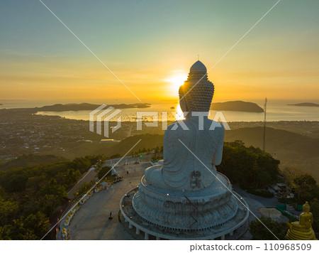Aerial view scenery yellow sun on the head of Phuket Big Buddha Aerial view scenery yellow sun on the head of Phuket Big Buddha 110968509