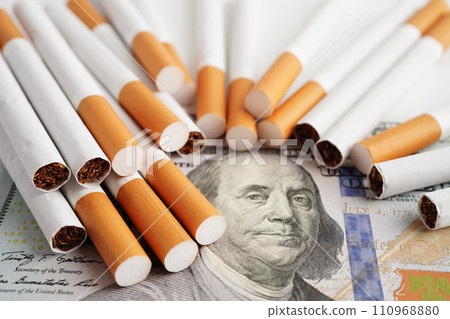 Cigarette on US dollar banknotes, cost, trading, marketing and production, No smoking concept. 110968880