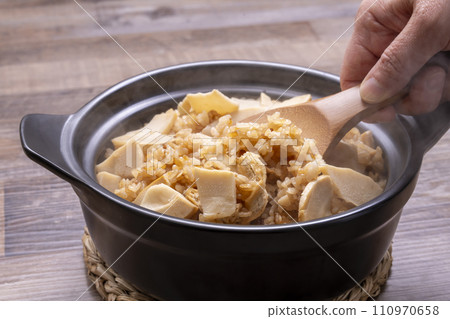 Bamboo shoots rice, freshly cooked in an earthenware pot, serve in a bowl Bamboo shoots rice, freshly cooked in an earthenware pot, serve in a bowl 110970658