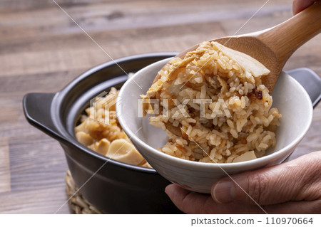 Bamboo shoots rice, freshly cooked in an earthenware pot, serve in a bowl Bamboo shoots rice, freshly cooked in an earthenware pot, serve in a bowl 110970664