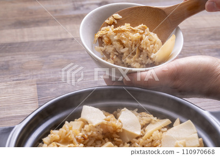 Bamboo shoots rice, freshly cooked in an earthenware pot, serve in a bowl Bamboo shoots rice, freshly cooked in an earthenware pot, serve in a bowl 110970668