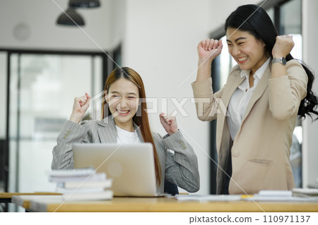 Excited Businesswomen Celebrating Success at Work. 110971137