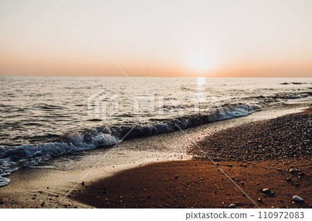 beautiful evening landscape on the sea. sunset of the setting sun. the sun disappeared behind the horizon of the sea. beautiful evening landscape on the sea. sunset of the setting sun. the sun disappeared behind the horizon of the sea. 110972083