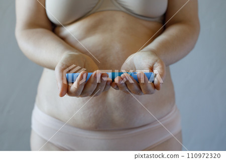 Woman hand holding semaglutide injection pen or insulin cartridge pen for diabetics and weight loss. Woman hand holding semaglutide injection pen or insulin cartridge pen for diabetics and weight loss. 110972320